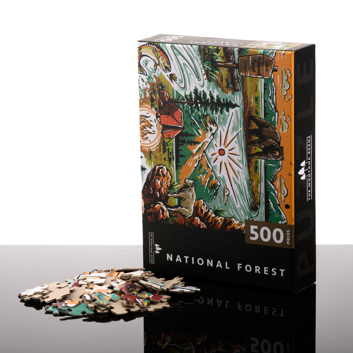 Hand drawn, Montana-made 500 piece puzzle by the Montana Scene--named National Forest-- featuring a bear, national forest sign, fly fishing, tent and mountain goat; image depicts the box front with puzzle pieces.