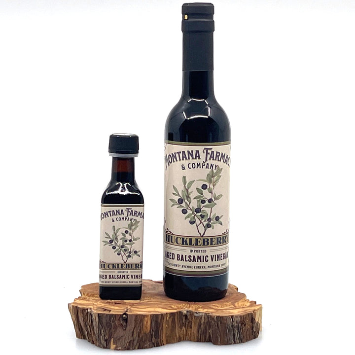 375 ml and 100 ml bottle of Montana Huckleberry Dark Aged Balsamic Vinegar, made in Montana by Montana Pharmacy