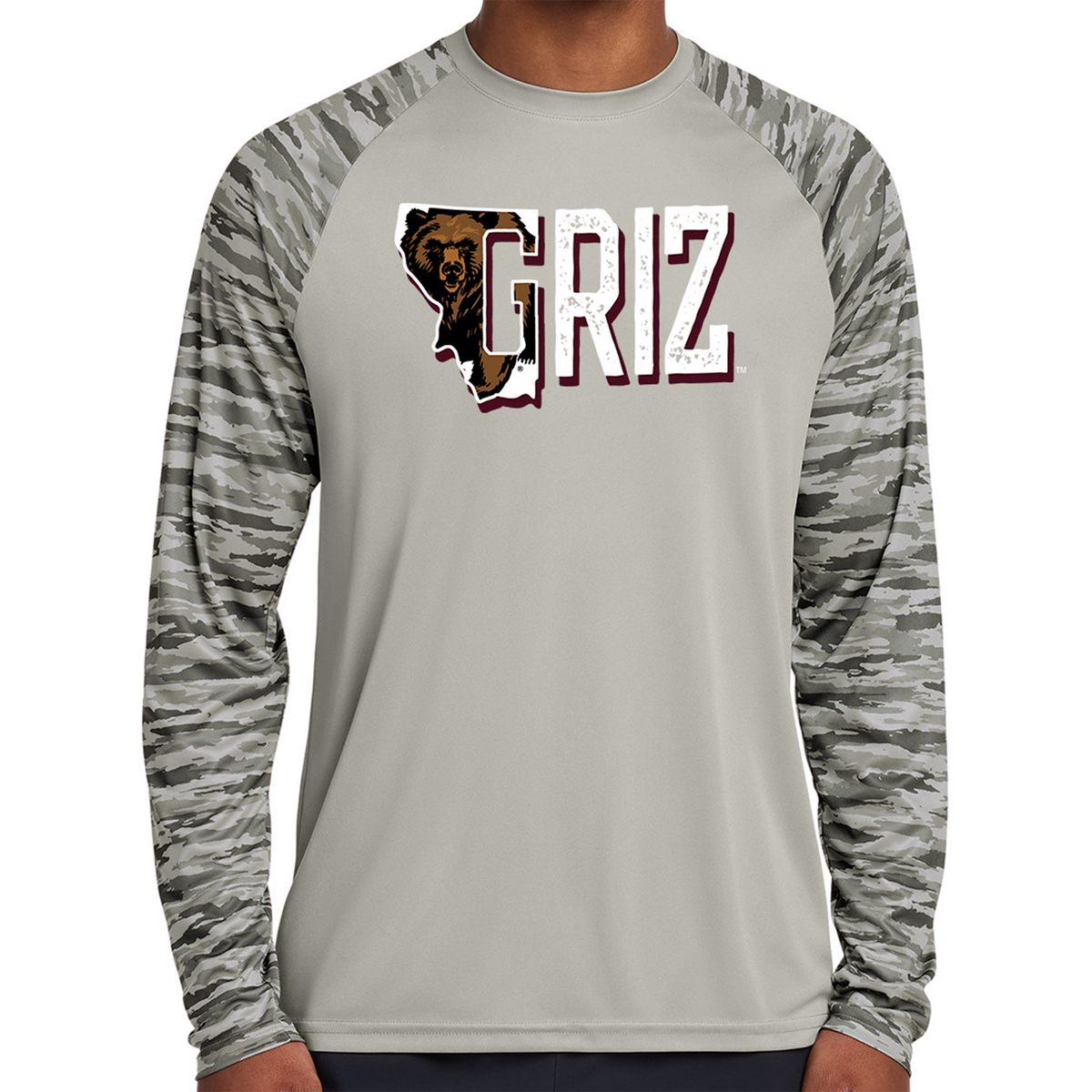 Show your Montana pride with the Charging Griz Drift Camo Colorblock Long Sleeve Tee. Lightweight, breathable, and featuring bold UM graphics. Shop now!