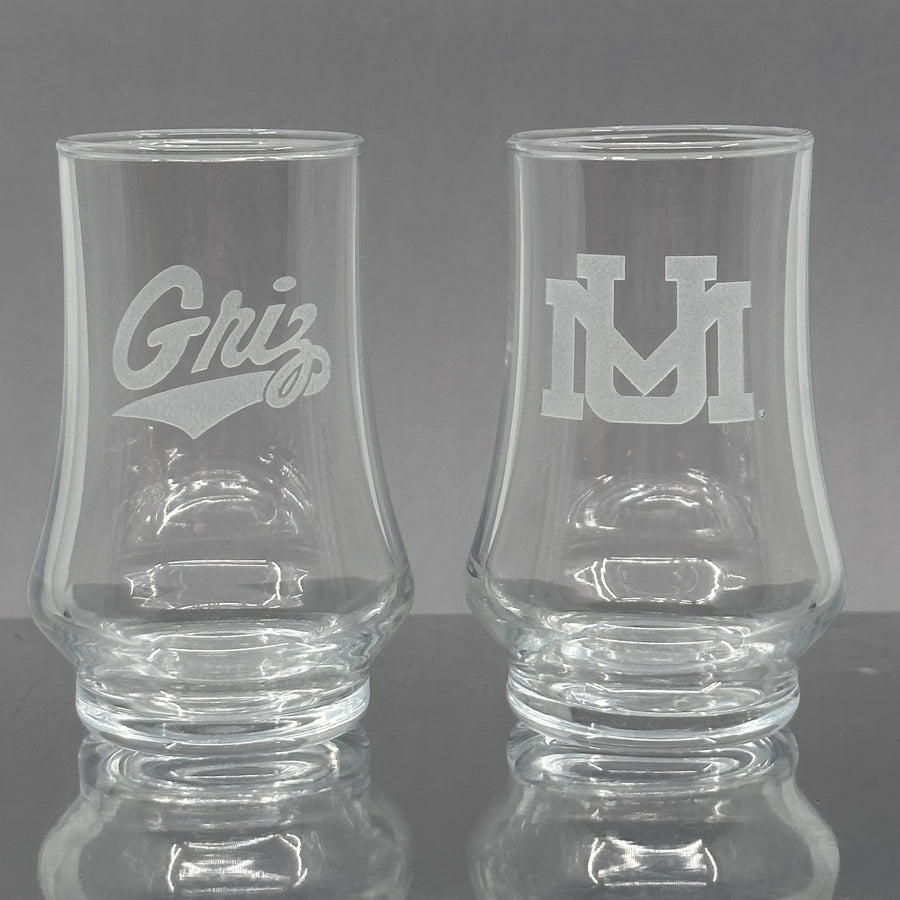 Blue Peaks Creative's 5.75 oz. glass  Kenzie Whiskey Tasters, sand carved with the UM and Griz Script designs