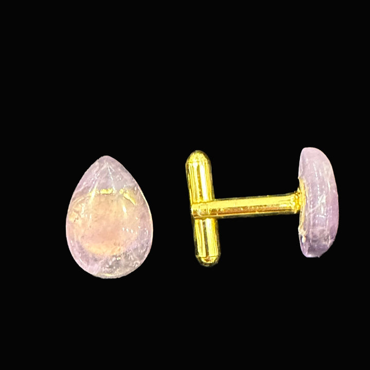 Teardrop amethyst cufflinks on a black background