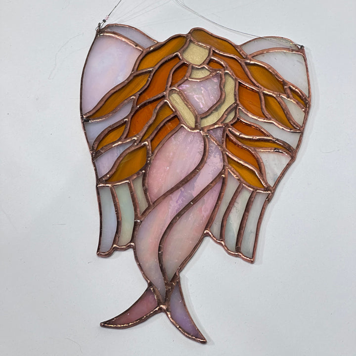 A stained glass angel with hair flowing made in Montana USA