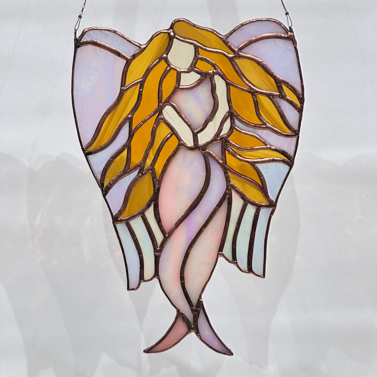 A stained glass angel with hair flowing made in Montana USA