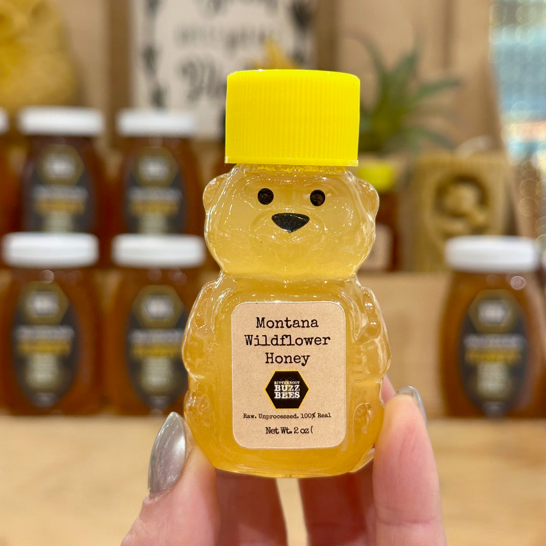 A mini 2oz Honey Bear with 100% raw Montana wildflower honey