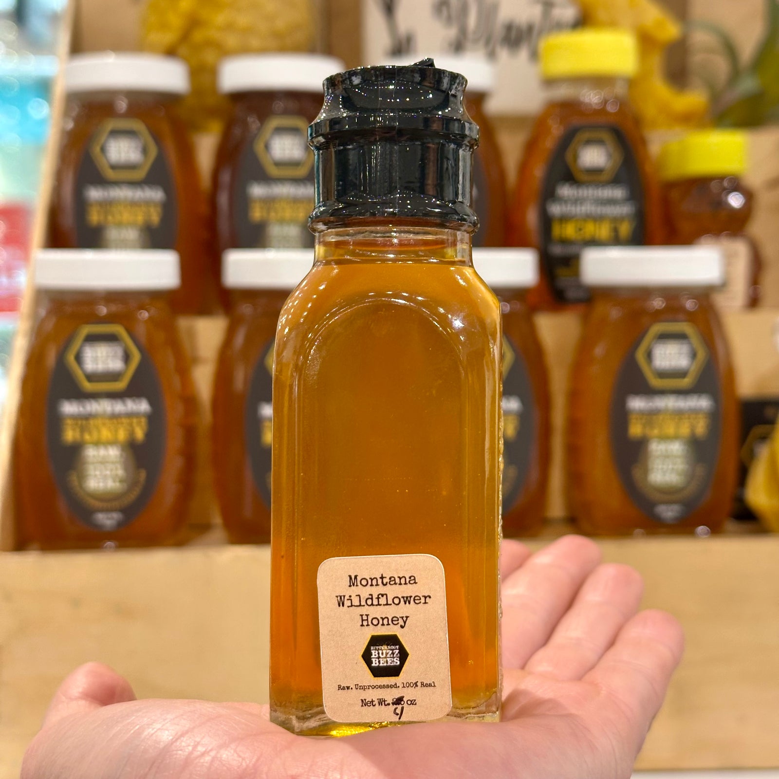 A 4oz Glass jar of 100% Raw Montana Wildflower Honey