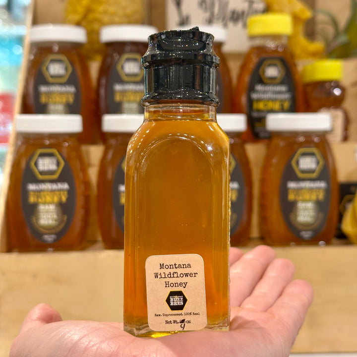 A 4oz Glass jar of 100% Raw Montana Wildflower Honey
