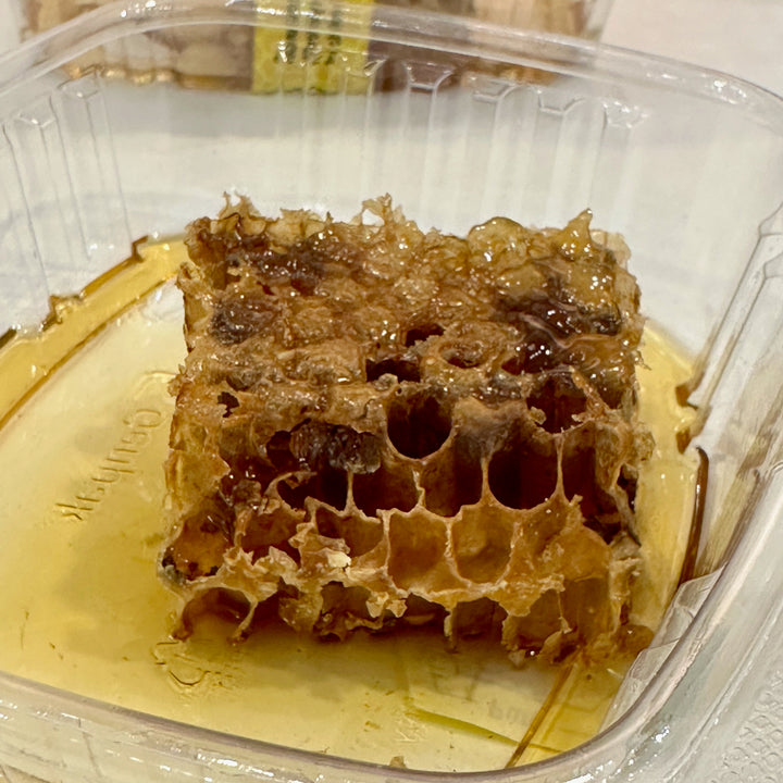 A close up of a chunk of 100% premium honeycomb