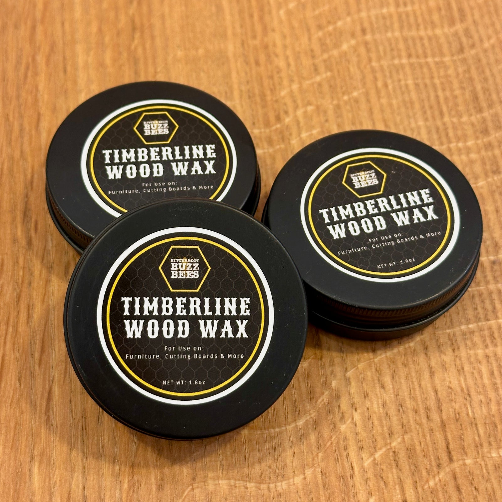 Three black tins of Timberline Wood Wax made with Montana Beeswax