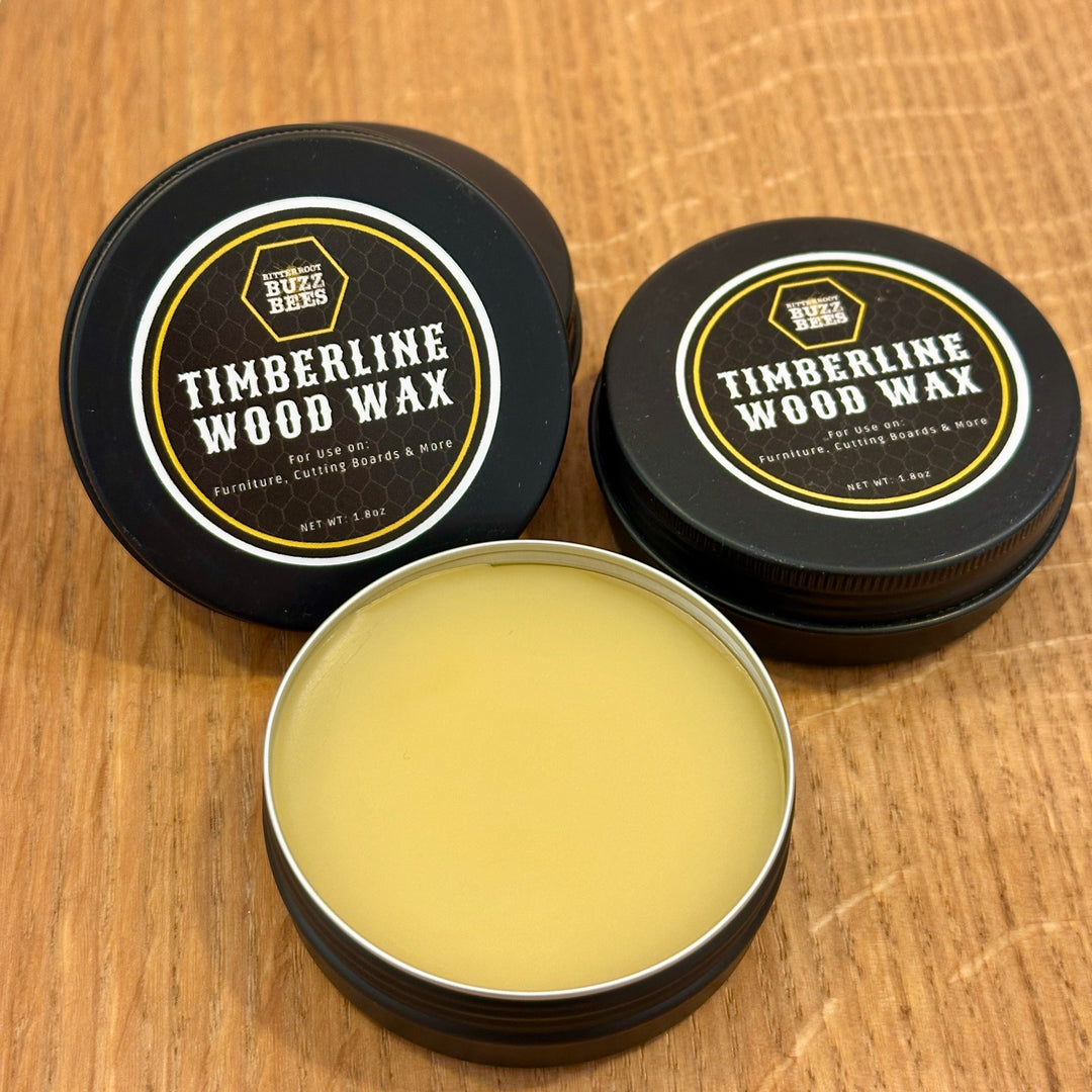 Two closed containers and one open container of Timberline wood wax made with 100% Montana Beeswax