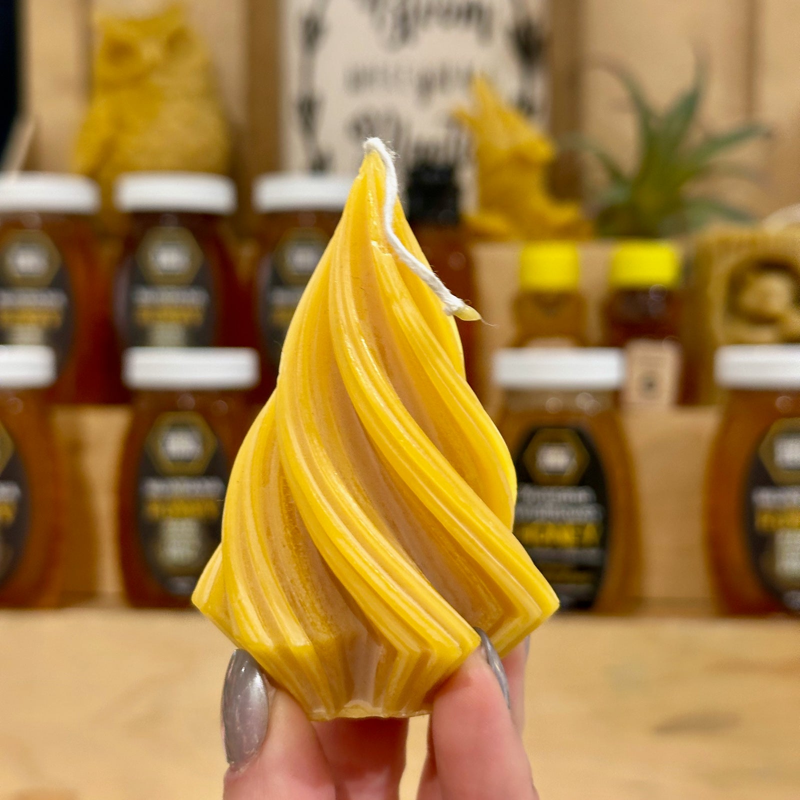 A swirling tree shaped candle made of 100% Montana beeswax