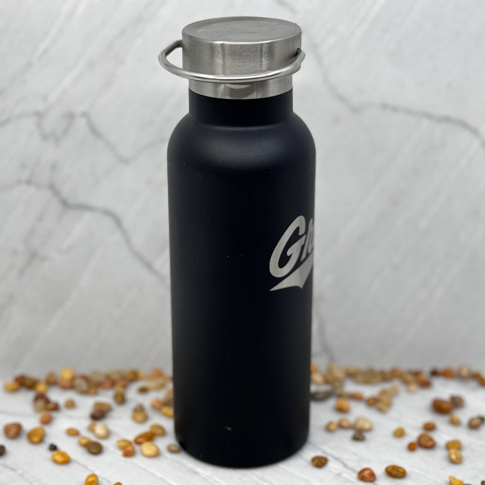 Black Griz Script Black 20oz Stainless Steel Tumbler made in Missoula, MT (home of the UM Grizzlies) by Blue Peak Creative—a black 20 oz. Stainless steel tumbler water bottle printed with a silver University of Montana Griz script (side)
