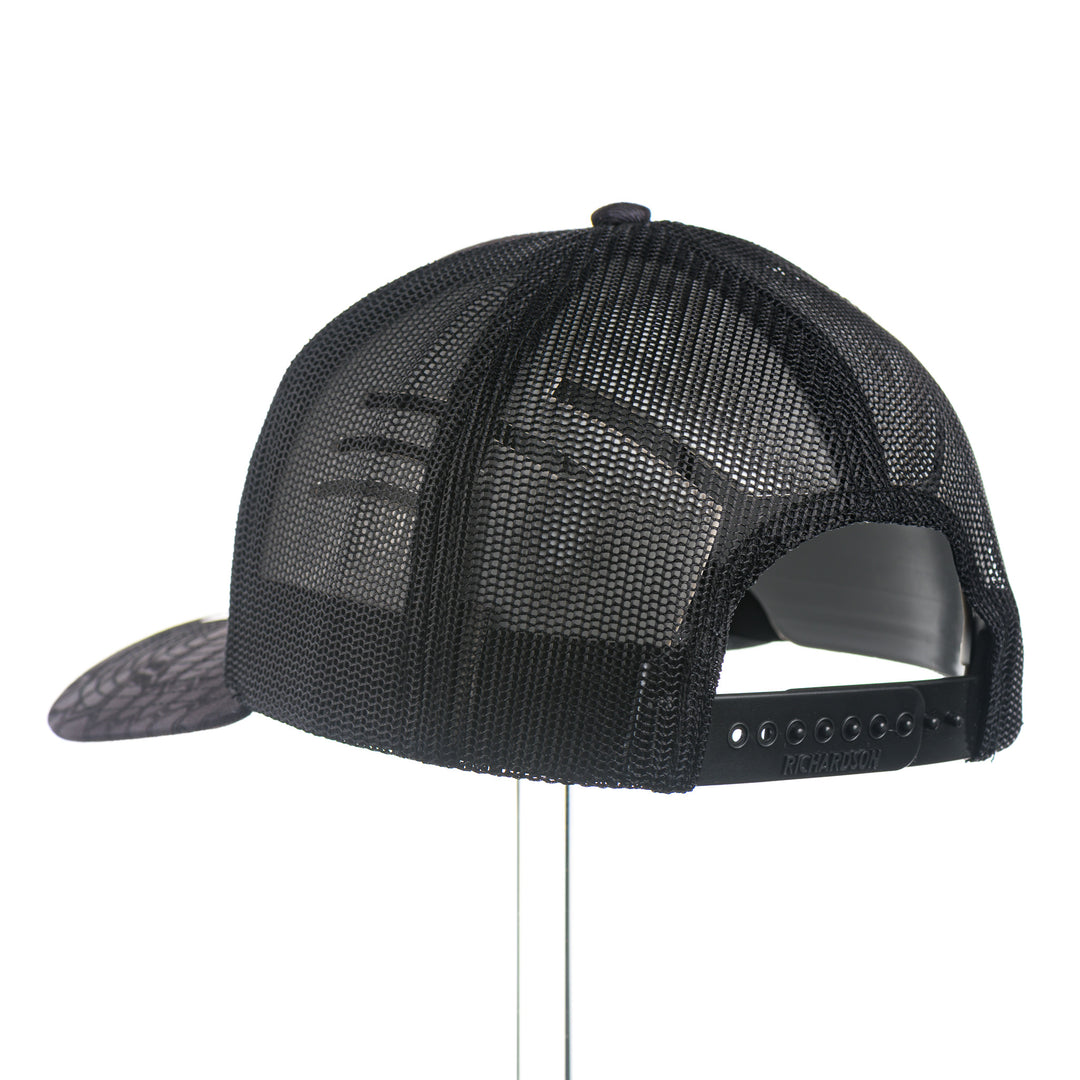 Back of a Black Leather Griz Script - Kryptek Trucker Cap—a black Kryptek camo Richardson 112 trucker hat with a black leather Griz Script patch, made in Missoula, Montana (home of the UM Grizzlies) by Blue Peak Creative