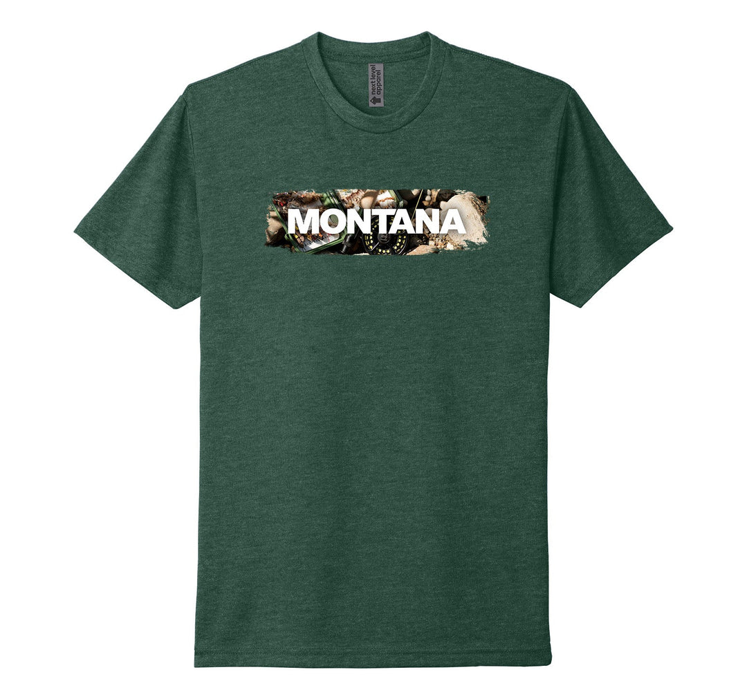 Heather forest green Next Level Apparel unisex adult tee featuring the official MT Department of Commerce ‘Montana’ lettering over the image of a a fly fishing reel, fly box, and river rocks, designed and printed in Montana by Blue Peak Creative
