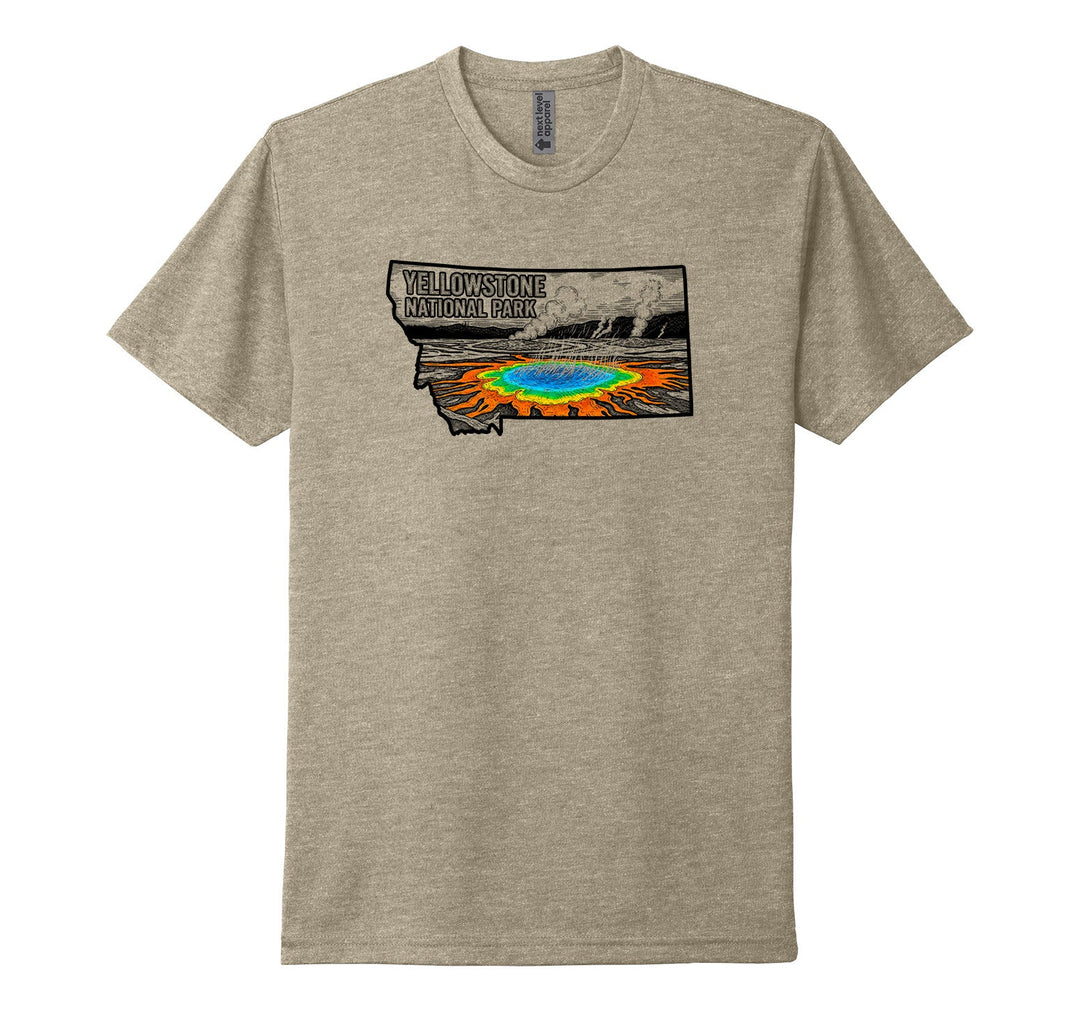 Heather tan Next Level Apparel unisex tee featuring a striking illustration of Yellowstone National Park’s most famous hot spring, Grand Prismatic Spring, rendered in brilliant color under the text ‘Yellowstone National Park’ and against a black and white background—all within the outline of the state of Montana, designed and printed in Montana by Blue Peak Creative