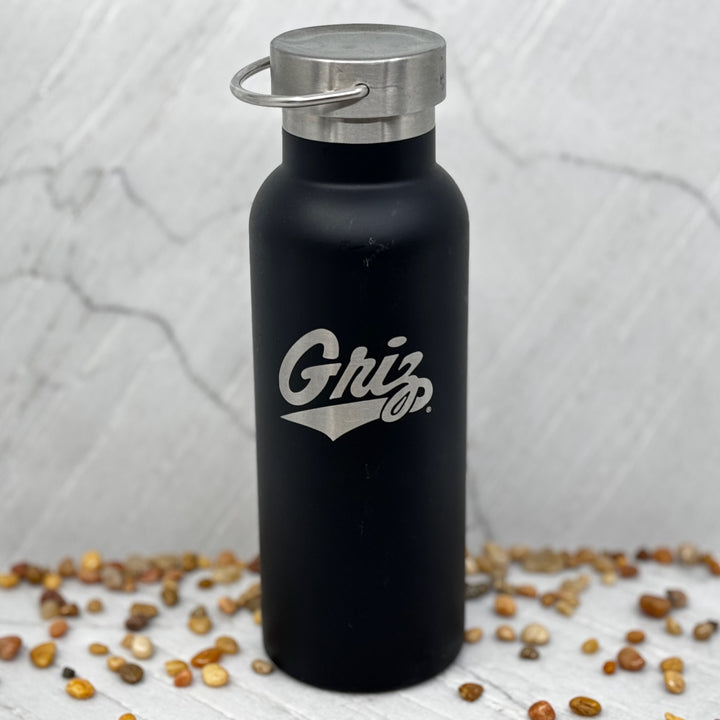 Black Griz Script Black 20oz Stainless Steel Tumbler made in Missoula, MT (home of the UM Grizzlies) by Blue Peak Creative—a black 20 oz. Stainless steel tumbler water bottle printed with a silver University of Montana Griz script (front)