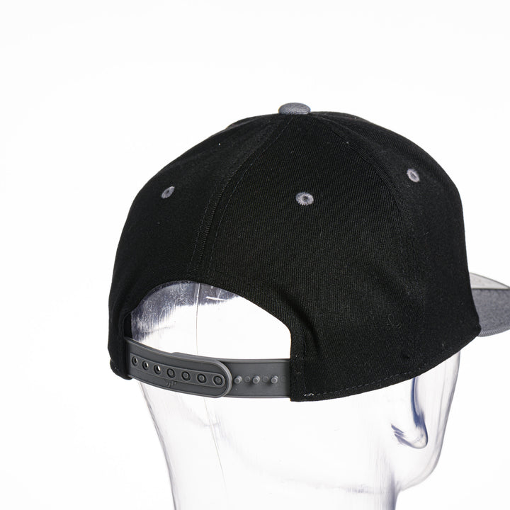 Black Montana Griz Script - Flat Bill Hat made in Missoula, MT (home of the UM Grizzlies) by Blue Peak Creative—a black flat bill hat embroidered with the University of Montana Griz script inside the outlined silhouette of the state of Montana (back).
