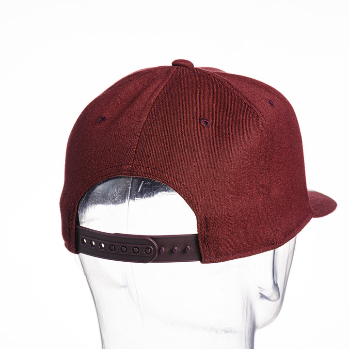 Maroon Montana Griz Script - Flat Bill Hat made in Missoula, MT (home of the UM Grizzlies) by Blue Peak Creative—a maroon flat bill hat embroidered with the University of Montana Griz script inside the outlined silhouette of the state of Montana (back).