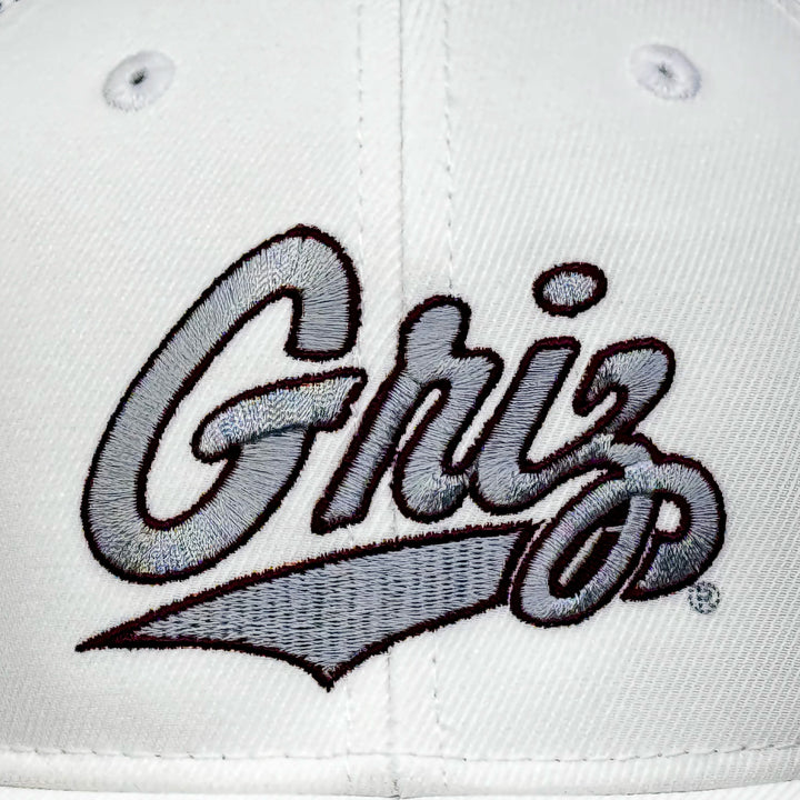 Embroidery detail of a white and grey Outlined Griz Script - Camo Hex Hat made in Missoula, MT (home of the UM Grizzlies) by Blue Peak Creative—a camouflage white and grey hat embroidered with the silver University of Montana Griz script outlined in maroon