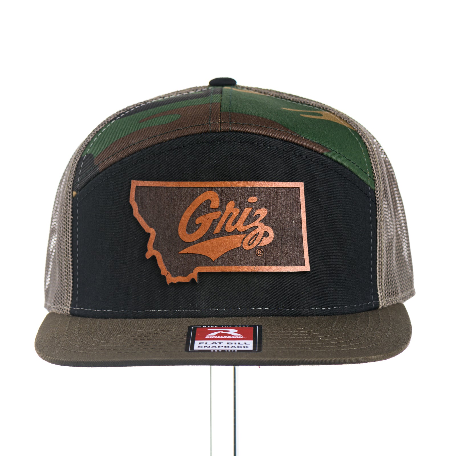 Camouflage and black trucker hat with University of Montana Griz logo Leather Patch on a white background