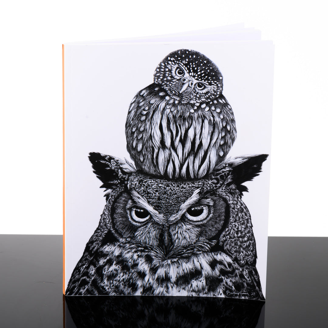 Notebook featuring original black and white artwork by Brittany Finch - an adorable little owl perched on the head of a Great Horned Owl - handmade by Brittany Finch Art in Montana