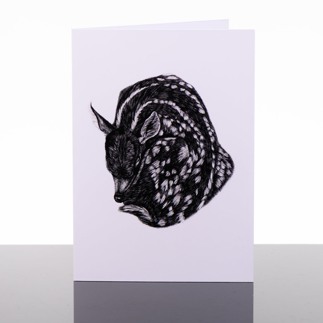 Blank greeting card featuring original black and white artwork by Brittany Finch - a spotted, curled, sleeping fawn - made in Montana by Brittany Finch Art