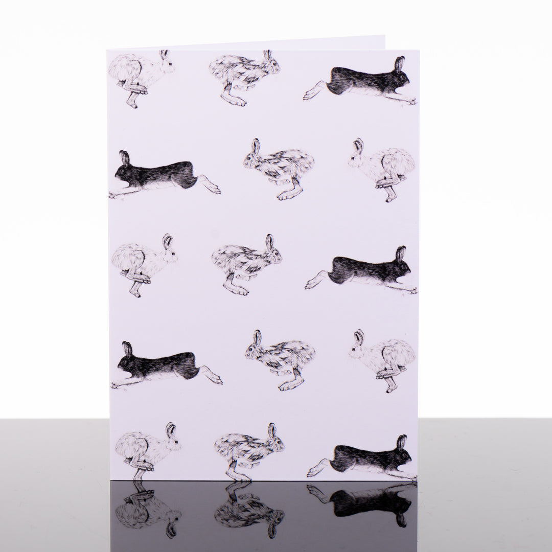 Blank greeting card featuring original black and white artwork by Brittany Finch - rows of racing hares in alternating directions - made in Montana by Brittany Finch Art