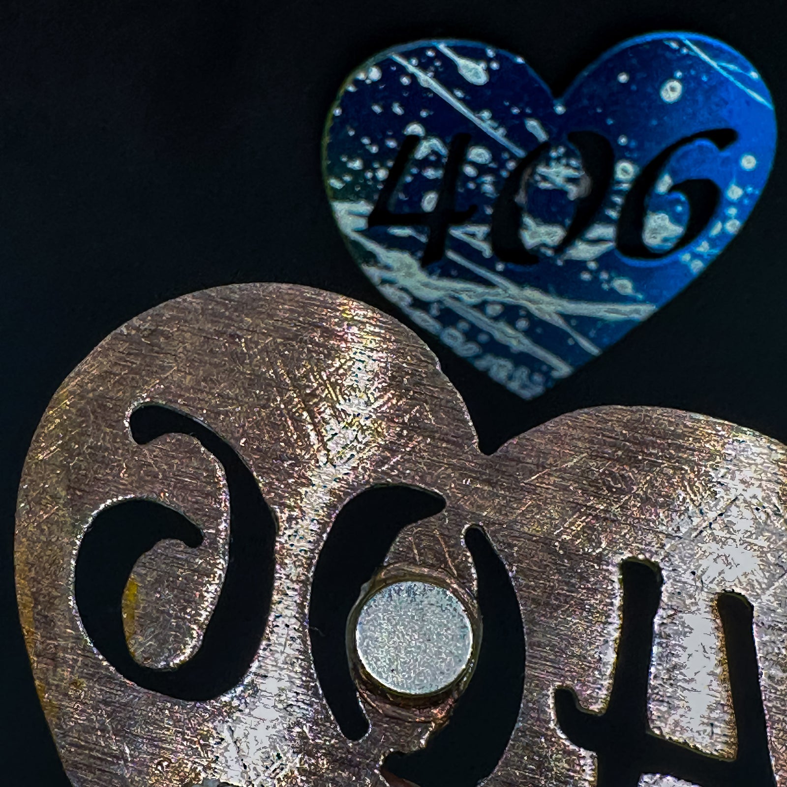 A made in Montana heart-shaped cut-out with a silhouette of the 406 area code embedded in it and a strong back magnet.