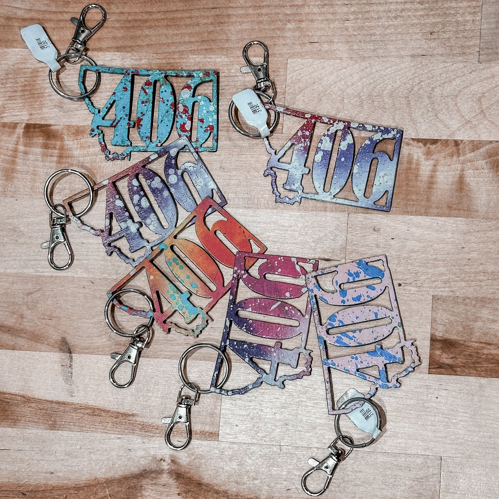 This Montana 406 Metal Keychain showcases a state-shaped design with a the 406 area code cut out of it