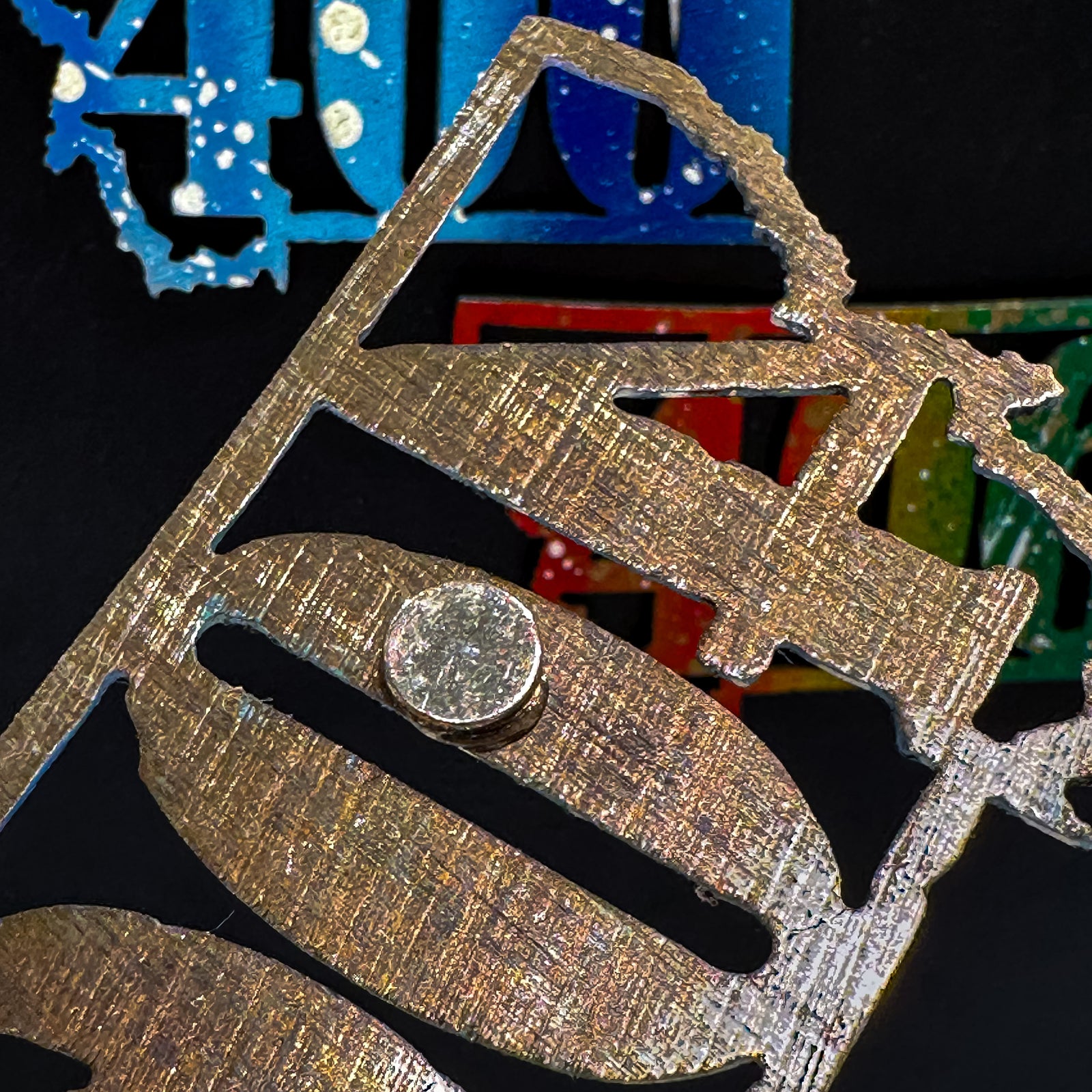 A made in Montana state-shaped cut-out with the area code 406 embedded in it and a strong back magnet.