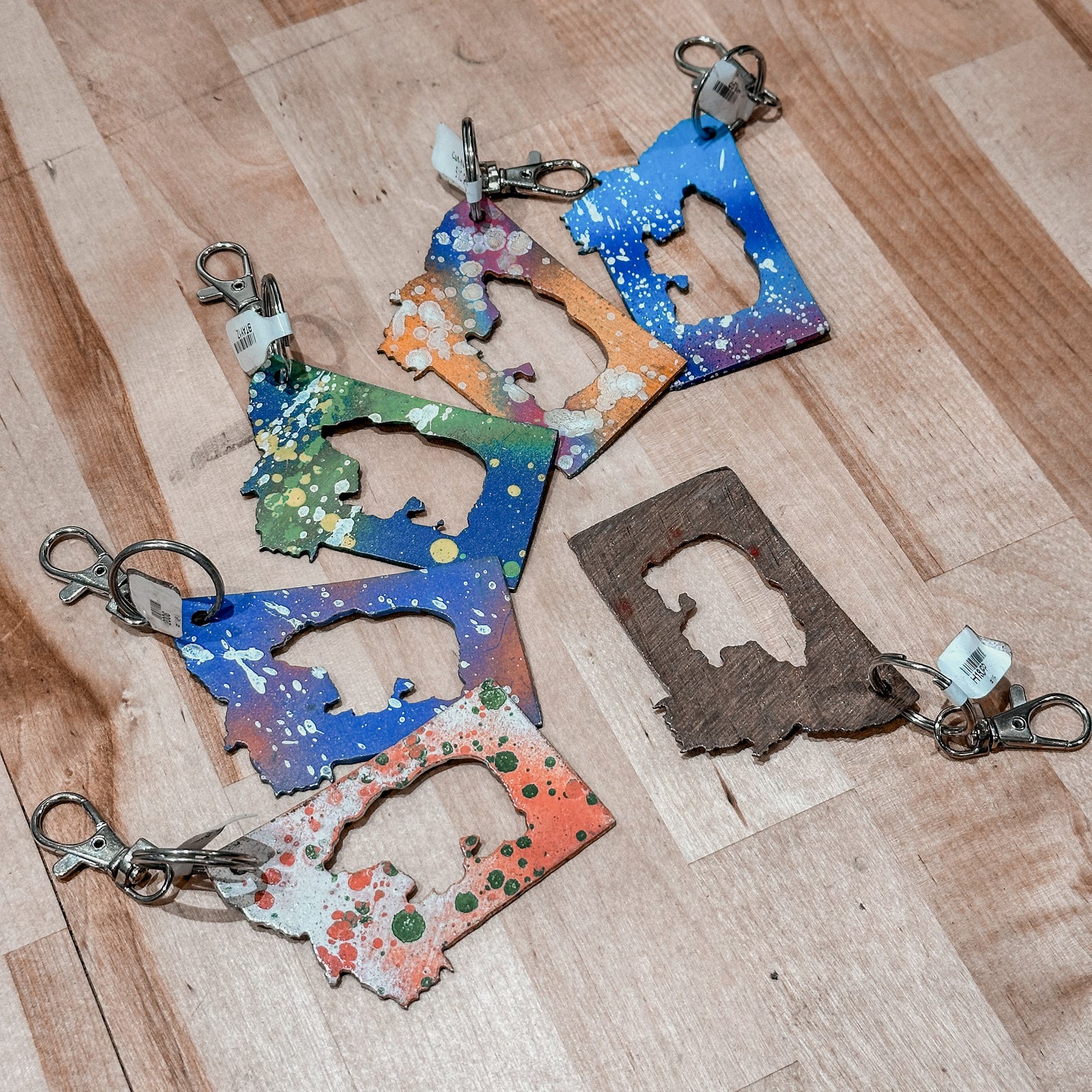 This made in Montana Bear Metal Keychain showcases a state-shaped design with a bear cut out of it.