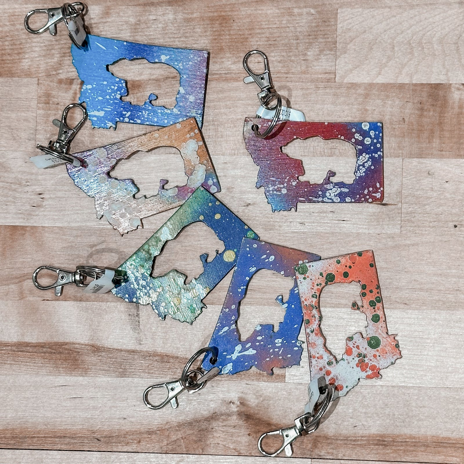 This made in Montana Bear Metal Keychain showcases a state-shaped design with a bear cut out of it.