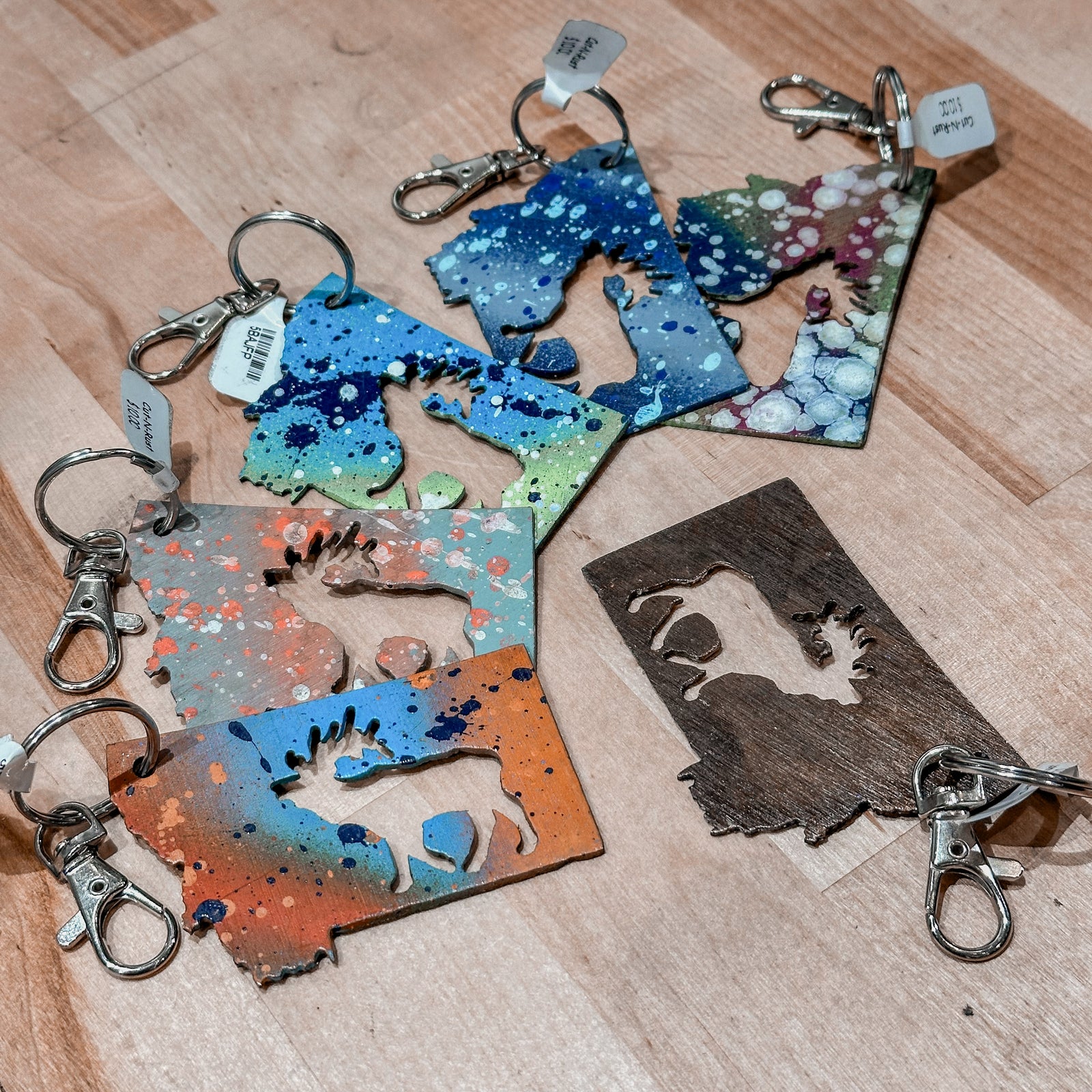 This made in Montana Elk Metal Keychain showcases a state-shaped design with an elk cutout in the center.