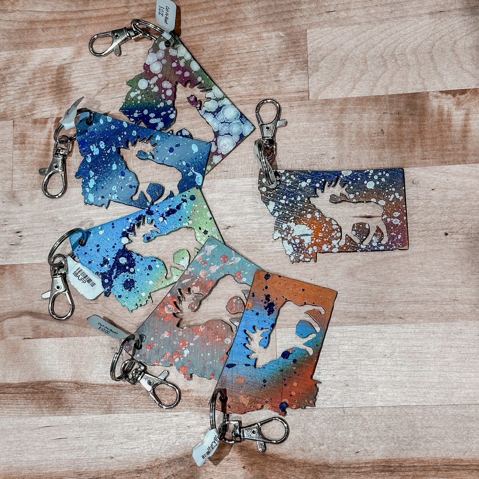 This made in Montana Elk Metal Keychain showcases a state-shaped design with an elk cutout in the center.