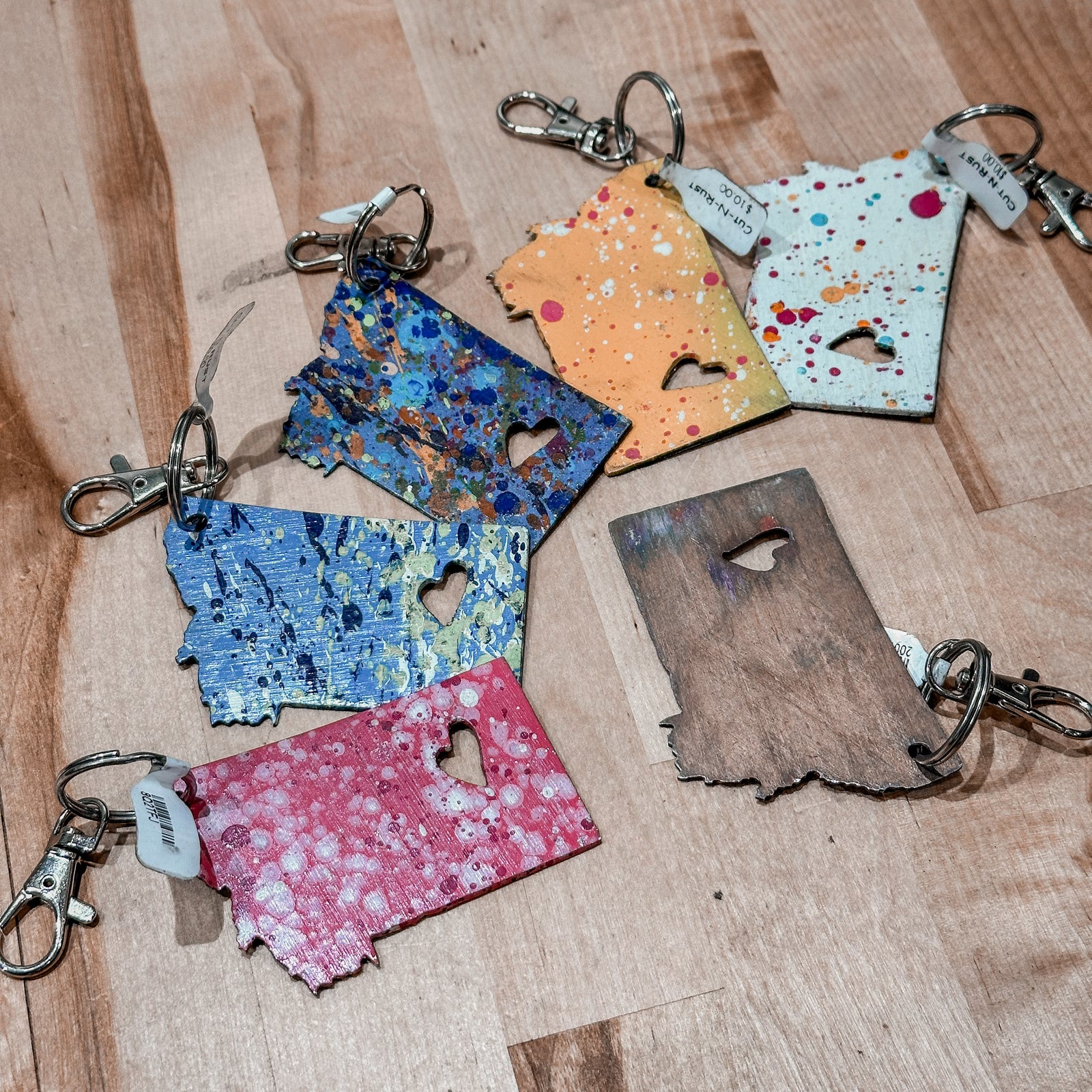 This made in Montana Heart Metal Keychain showcases a state-shaped design with a heart cut out of it.