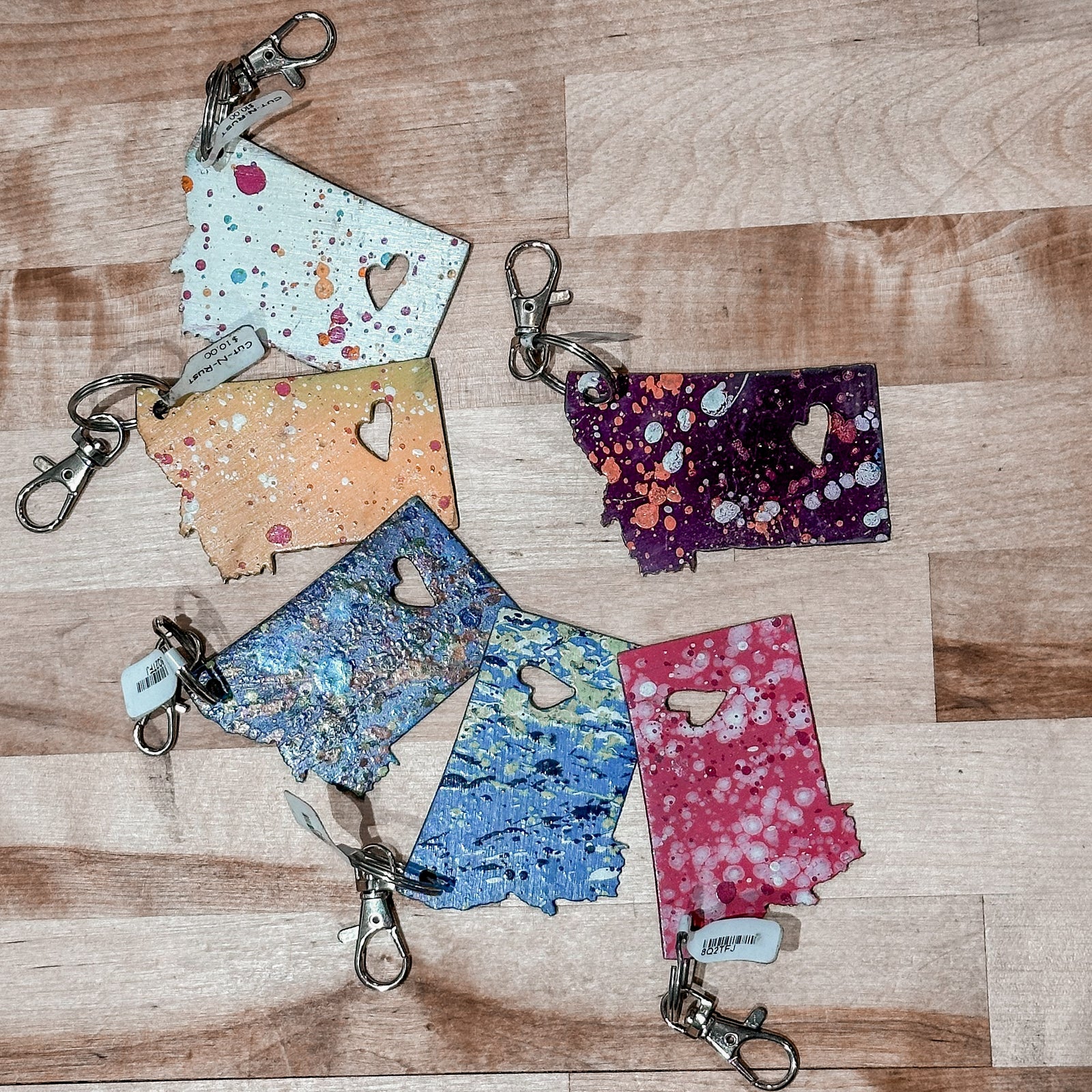 This made in Montana Heart Metal Keychain showcases a state-shaped design with a heart cut out of it.