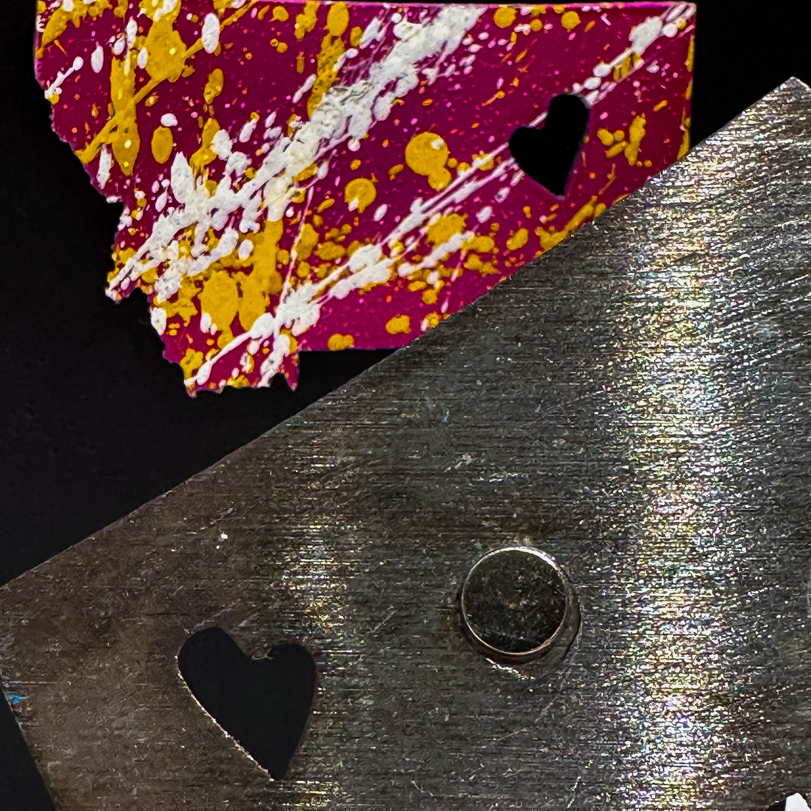 A made in Montana state-shaped cut-out with a heart silhouette embedded in it and a strong back magnet.