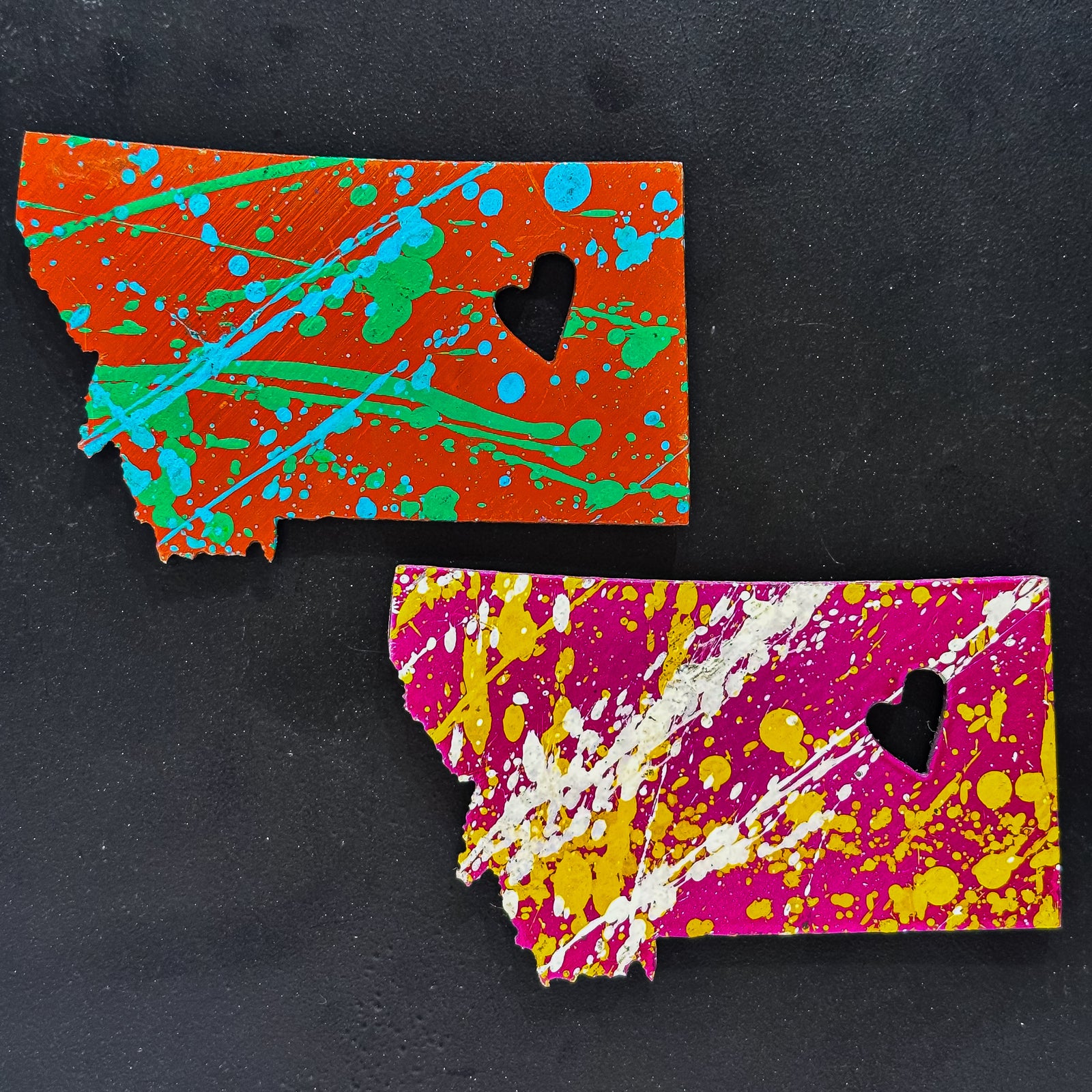 A made in Montana state-shaped cut-out with a heart silhouette embedded in it and a strong back magnet.