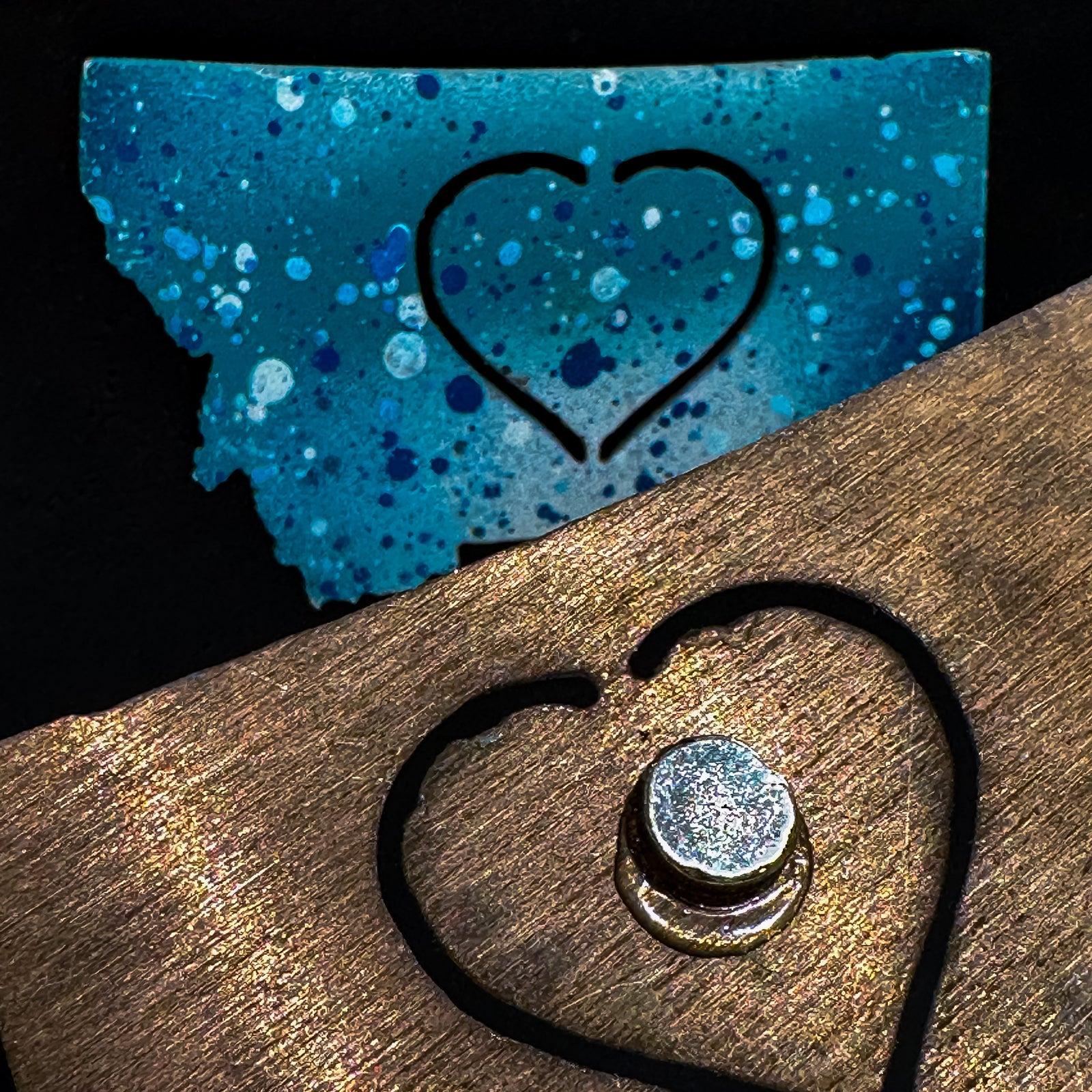 A made in Montana state-shaped cut-out with a heart silhouette embedded in it and a strong back magnet.