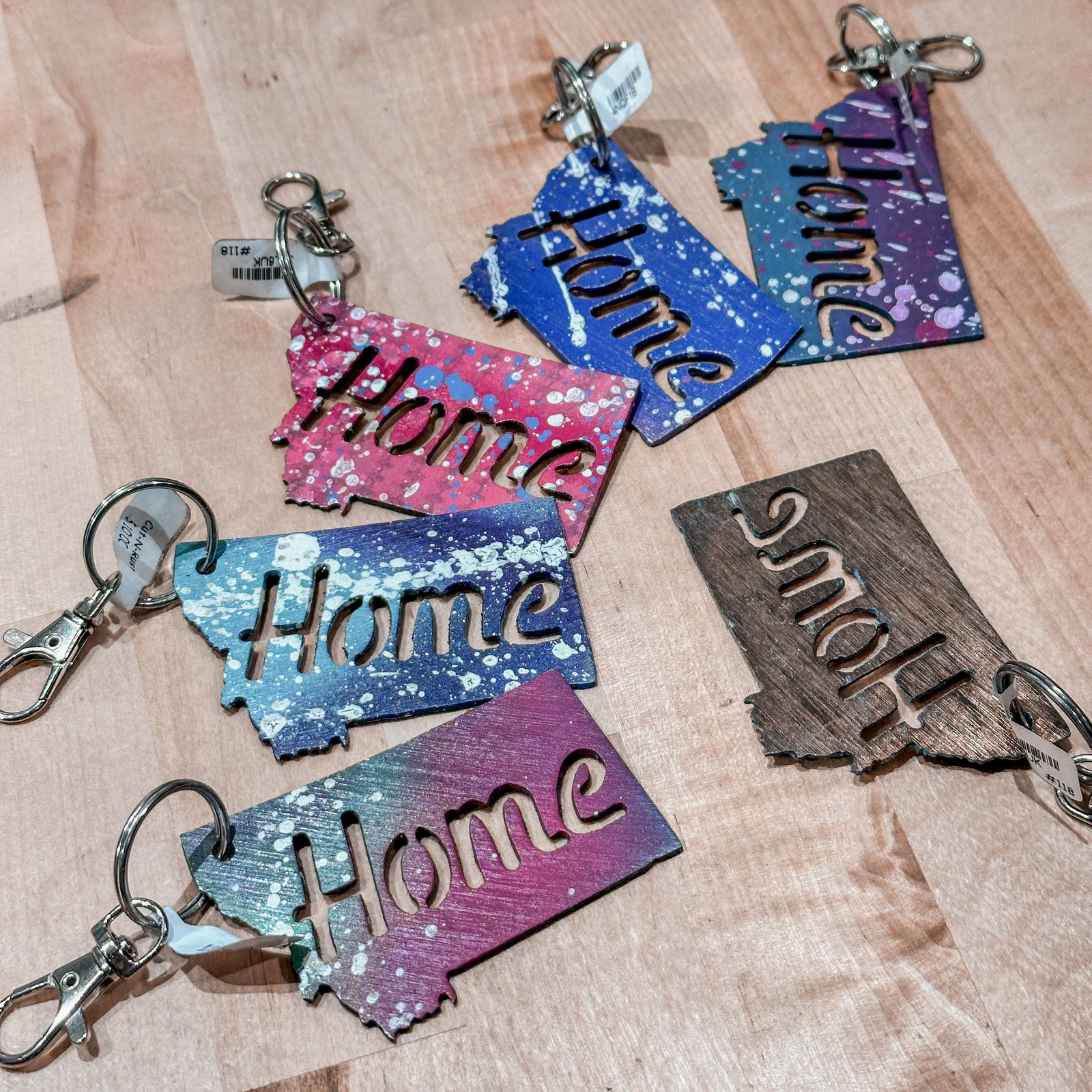 This made in Montana Home Metal Keychain showcases a state-shaped design with the word Home cut out of it.