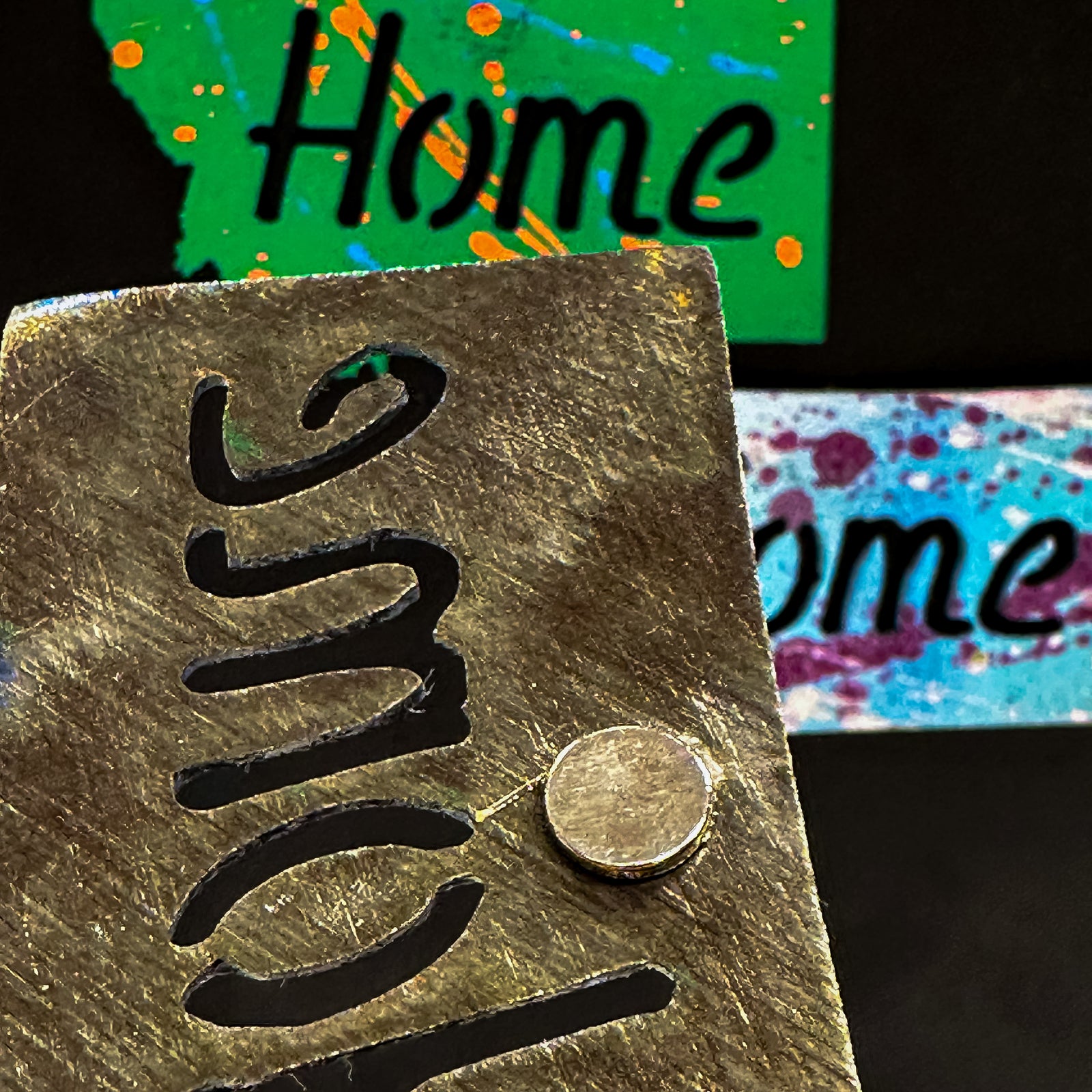 A made in Montana state-shaped cut-out with the word Home embedded in it and a strong back magnet.