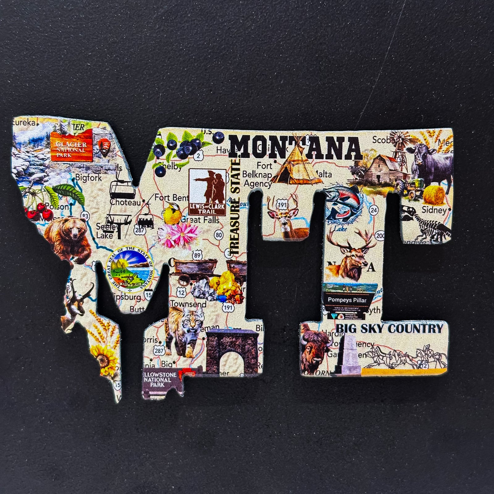 A made in Montana MT and state shaped magnet with a full color map printed on it. Featuring a strong backed magnet.