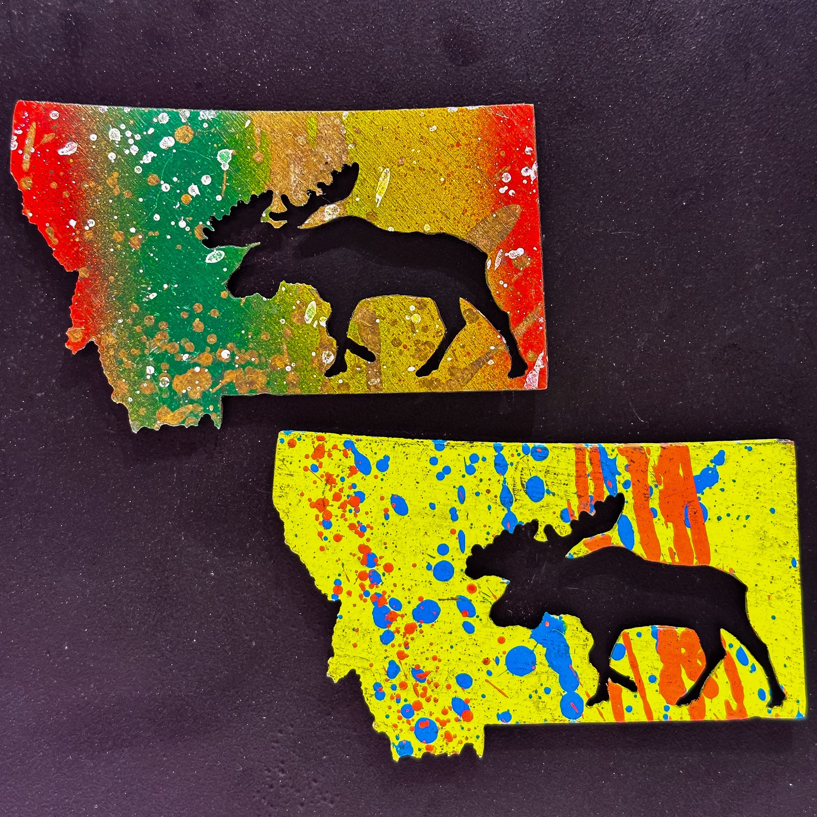 A made in Montana state-shaped cut-out with a moose silhouette embedded in it and a strong back magnet.