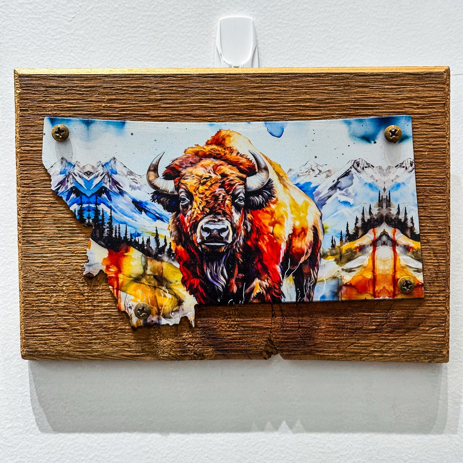 This Metal and wood plaque is in the shape of Montana with a vibrant print of a Bison. Made in Montana.