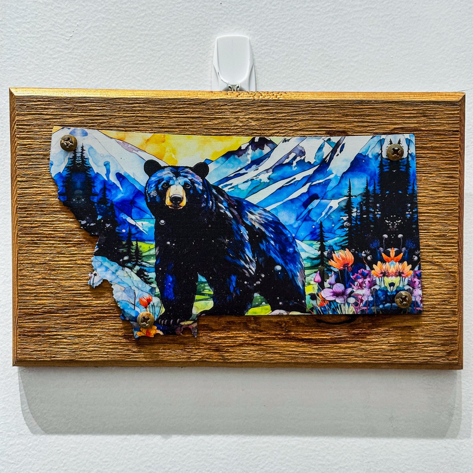 This Metal and wood plaque is in the shape of Montana with a vibrant print of a Black Bear. Made in Montana.