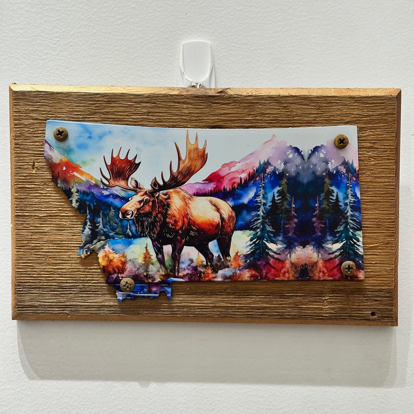 This Metal and wood plaque is in the shape of Montana with a vibrant print of a Moose. Made in Montana.