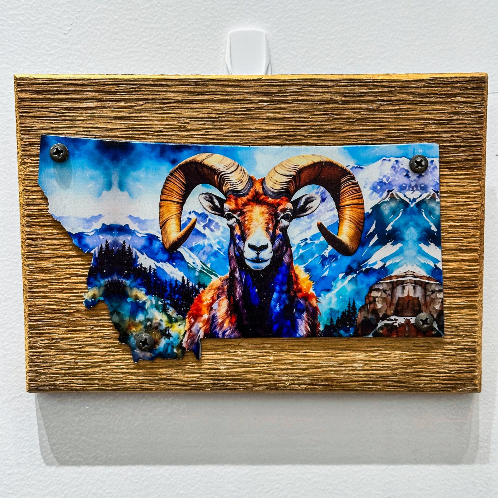 This Metal and wood plaque is in the shape of Montana with a vibrant print of a Ram. Made in Montana.