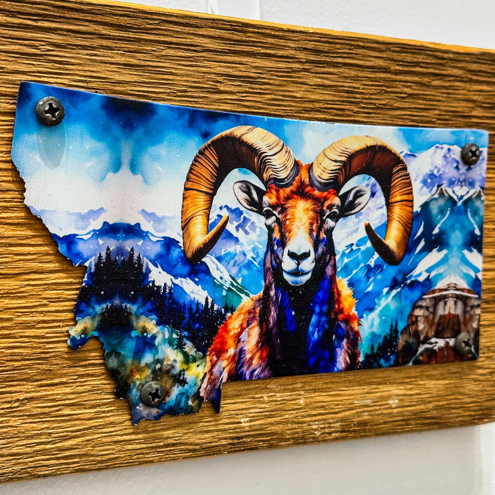 This Metal and wood plaque is in the shape of Montana with a vibrant print of a Ram. Made in Montana.