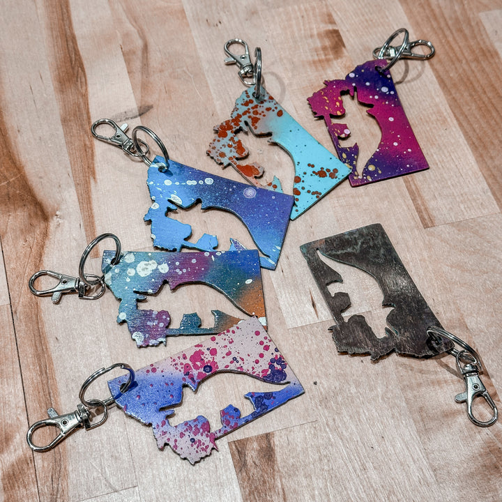 This made in Montana Triceratops Metal Keychain showcases a state-shaped design with a triceratops cut out of it.