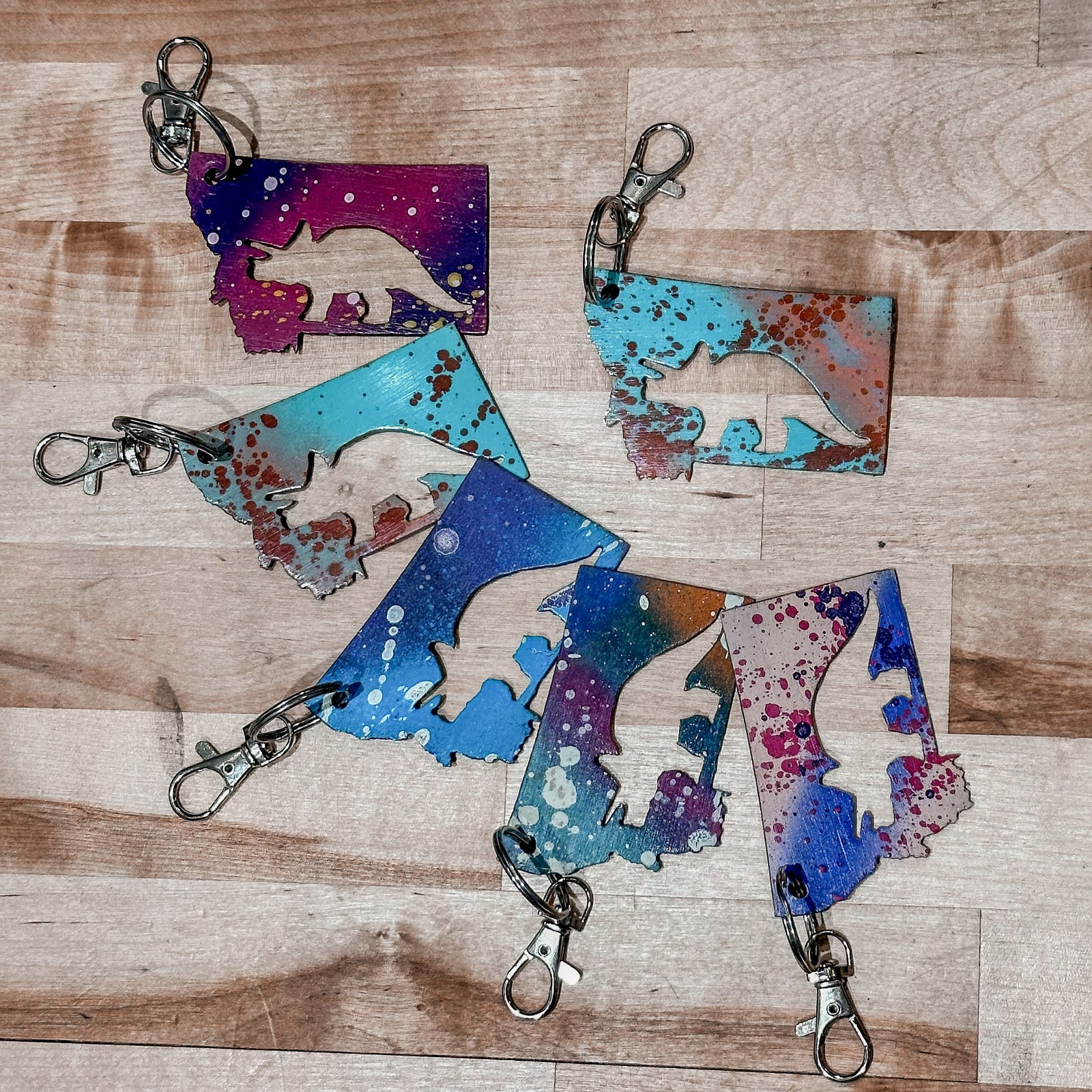 This made in Montana Triceratops Metal Keychain showcases a state-shaped design with a triceratops cut out of it.