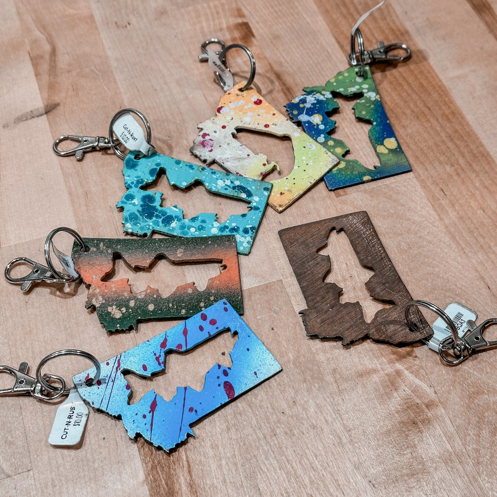 This made in Montana Trout Metal Keychain showcases a state-shaped design with a trout cut out of it.